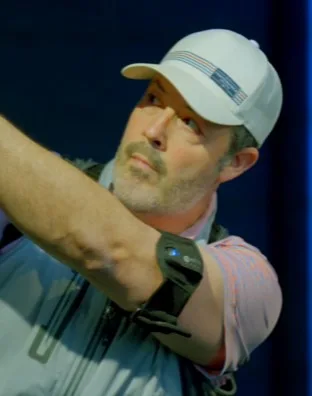 Golfer wearing K-Motion arm sensor mid-swing at Upstate Golf Rx